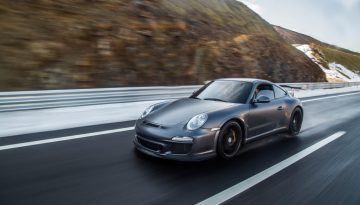 mini-coupe-driving-highway-accross-mountains
