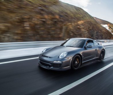 mini-coupe-driving-highway-accross-mountains